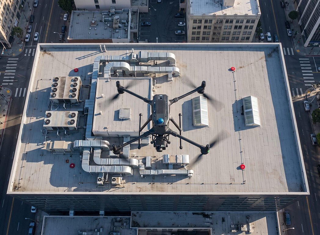 Top-down view of an inspection drone over a rooftop with HVAC ductwork, thermal drone inspection